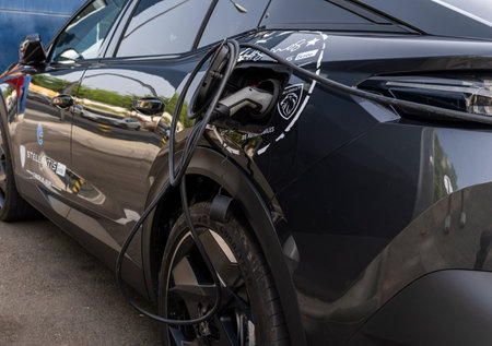 Palma de Mallorca, Spain; August 10 2023: Black Peugeot electric car recharging the battery at an electric charging point. Palma de Mallorca, Spainのeditorial素材