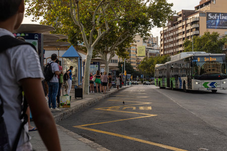 Palma de Mallorca, Spain; September 11 2023: Bus stop with passengers waiting the bus of the public company EMT, Palma de Mallorca, Spainのeditorial素材