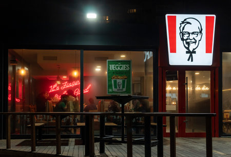 Palma de Mallorca, Spain; March 29 2024: Main facade of a franchise restaurant of the multinational fast food company KFC, at nightのeditorial素材