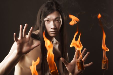 Portrait of asian man with fireの写真素材