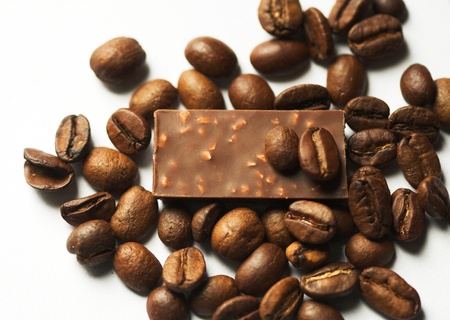 Coffe and pieces of milk chocolade on light background.の写真素材