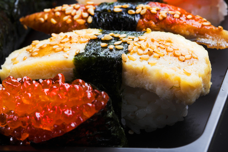 Seafood. Sushi and rolls on the black dish.の写真素材