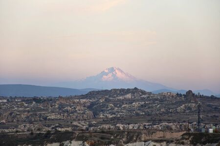 The Goreme National Park and mount Erciyes in Cappadocia at the eveningの写真素材
