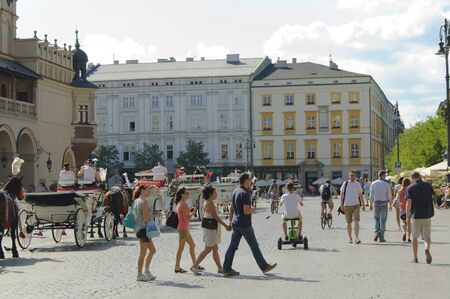 Krakow, Poland - July 2, 2015 : Krakow's residents and tourists walk on the Main Market Square - the central city squareのeditorial素材