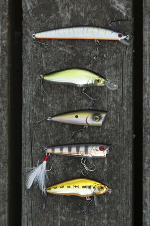 Several wobblers and poppers laying on the planks of boardwalkの写真素材