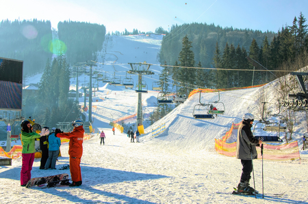 Bukovel, Ivano-Frankivsk region, Ukraine - 27 January 2018: People enjoying skiing and snowboarding at the skiing pisteのeditorial素材