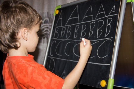 boy writing lettersの写真素材