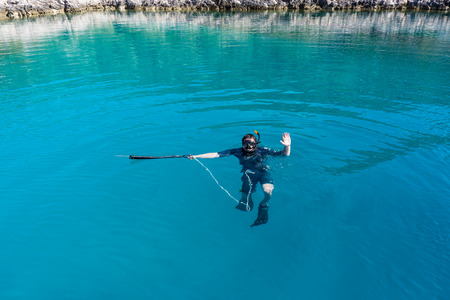 underwater hunter with a gun in a mask. speargunの写真素材