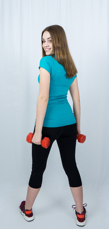 girl with dumpbells on white background sport concept gymの写真素材