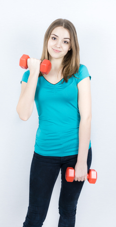 girl with dumpbells on white background sport concept gymの写真素材