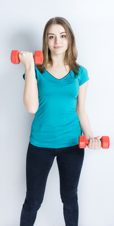 girl with dumpbells on white background sport concept gymの写真素材