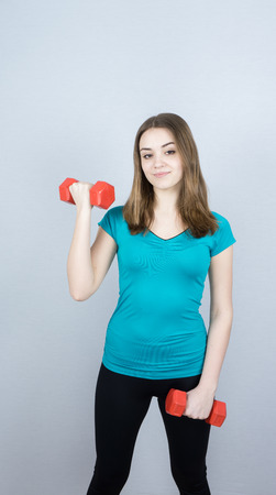 girl with dumpbells on white background sport concept gymの写真素材