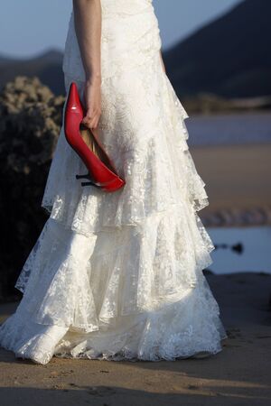 Bride holding red shoes.の写真素材