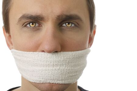 Young man with bandage covering his mouth on white