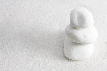 White zen stones with white sand all over.の写真素材