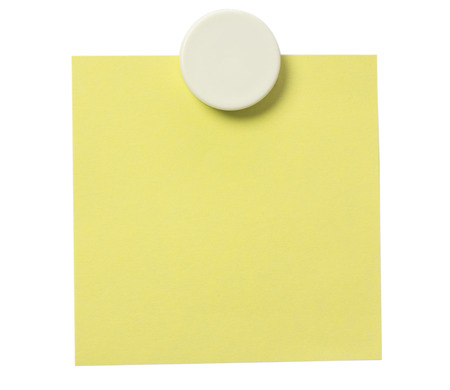 Yellow adhesive note and white magnet button on whiteboard.の写真素材