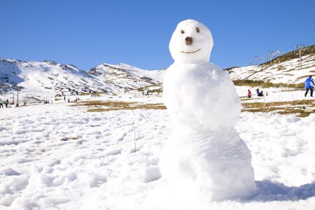 Snowman in a mountain pass in a sunny day.の写真素材