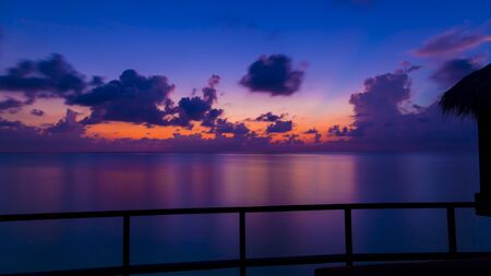 Gorgeous dusk in Maldives. Shot is from the deck of an over water bungalow.の写真素材