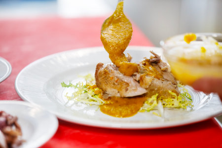 Chef is placing some sauce over quail in a saladの写真素材