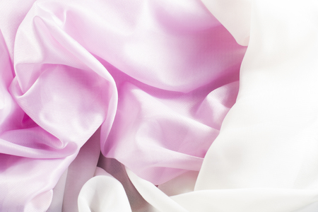 crumpled delicate pink silk as backgroundの写真素材