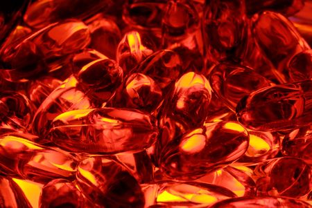 A chaotic arrangement of red capsules, lit from within.  の写真素材