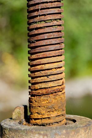 Screw of a flood gate, covered with a layer of rust の写真素材