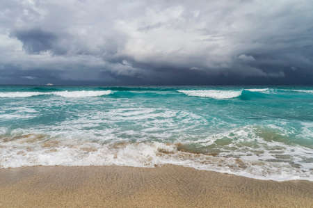 storm in the Atlantic Ocean, waves, beach, coastline, white yacht on the horizon, low cloudiness, Varadero, Cubaの写真素材