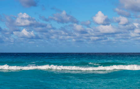 line of the ocean, small waves, horizon, endless distance, against the sky covered with clouds, Cubaの写真素材