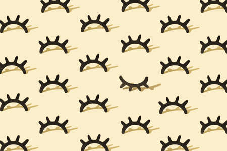 Creative pattern with wooden eyelashes on a pastel yellow background. Minimalist concept. Isometric...