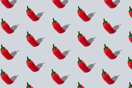 Seamless red chili peppers pattern on light grey background.の写真素材