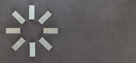 New metal staples for stapler top view on dark backgroundの写真素材