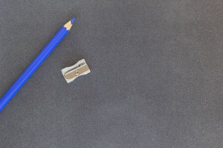 Blue colored pencil on dark background top viewの写真素材