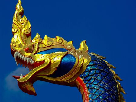 A Naka head statue on an entrance to a temple in Nakorn Nayok, Thailand.の写真素材