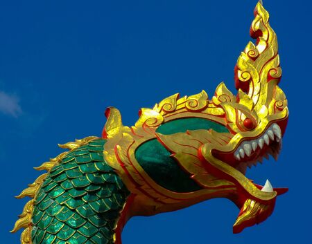 A Naka head statue on an entrance to a temple in Nakorn Nayok, Thailand.の写真素材