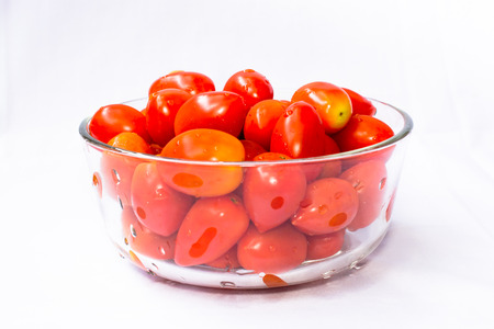 Red tomatoes pre-wash and put in glass bowl の写真素材