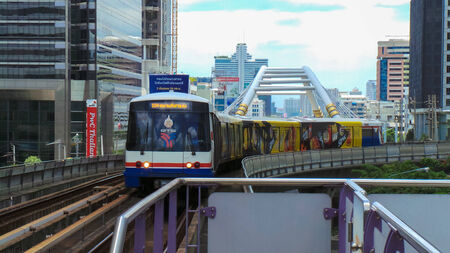 Electric railway train runing through the inner Bangkok Metropolitan business district and to the...