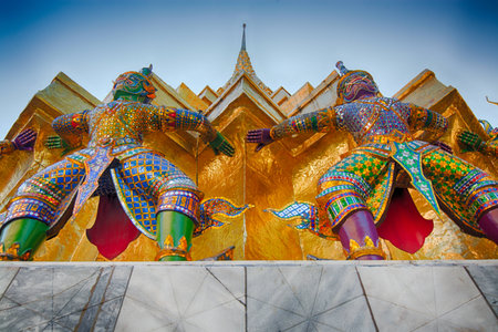 Giant guardian sculptures supporting the base of a pagode in Wat Phra Kaew, Bangkok Thailand.の写真素材