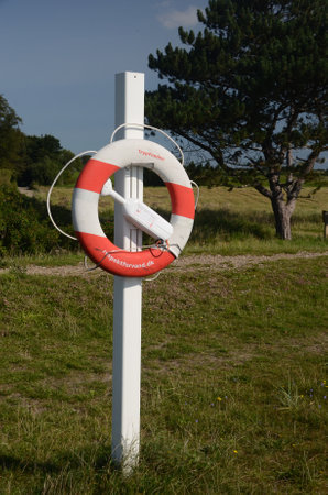 Skovby, Denmark - August 23, 2017: Life post with life ring and tracking transmitter.のeditorial素材