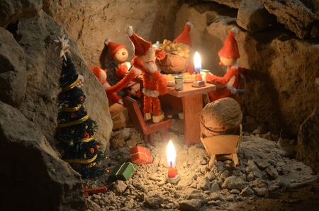 Pixie gang eating a Christmas meal in an underground den, only with light from the candles.の写真素材