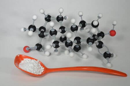 Molecule model of Stevia, the central element in a natural sweetener with sample in an orange spoon....