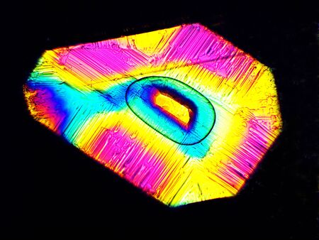 Crystal layer on microscope object glass, seen in polarized light. This causes random unforeseeable...