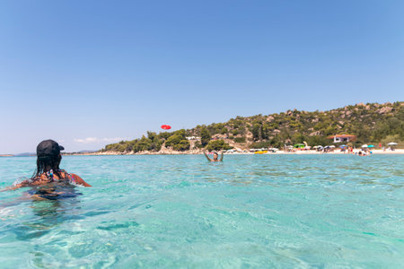 Happy young couple playing with a plastic disc in the sea. Travel, vacation and funの写真素材