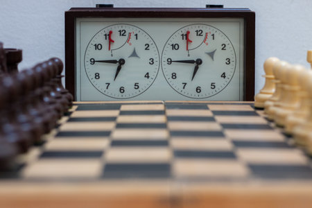 Chess board with chess game being played against white background. Opening gameの写真素材