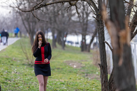 A charming sweet teenager who enjoys nature and smells flowers.の写真素材