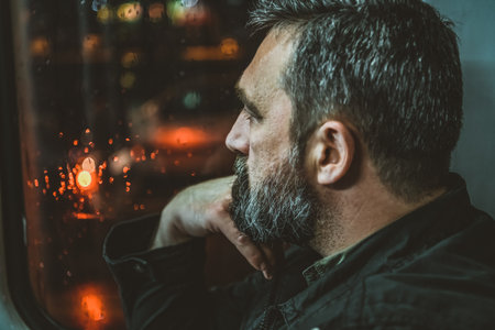 Mature man sitting at the window a public bus. Mature Sad Man On The Bus Window.