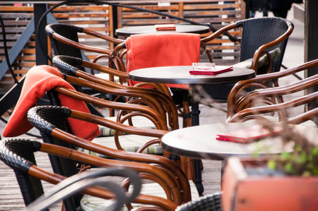 Empty coffee terrace with wooden tables and chairs.