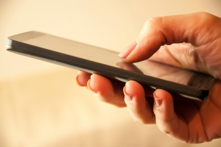 Close up of female hands using a smart phoneの写真素材