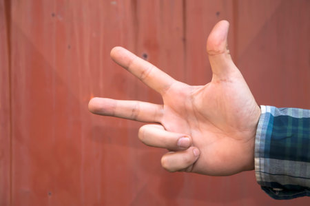 Close up view of male hand showing a three fingersの写真素材