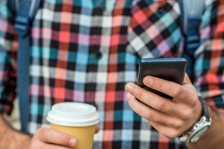 A handsome hipster
man sending text message. City lifeの写真素材