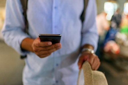 Close up View of Businessman with a Smart Phone in the City Streets During a Nightの写真素材